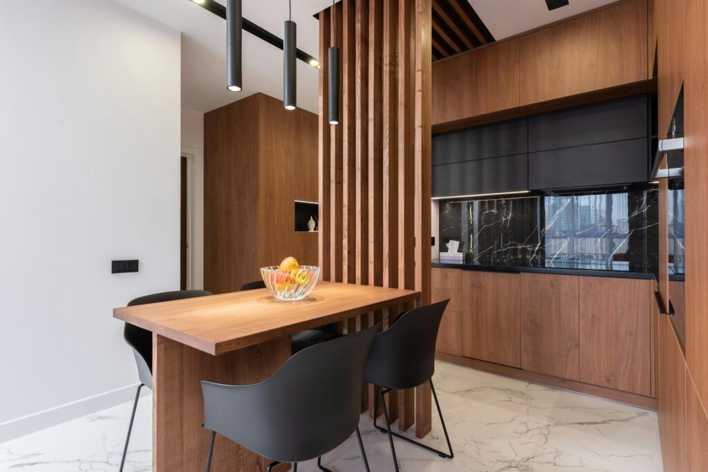 A sleek and stylish kitchen interior featuring wooden cabinetry and contemporary design elements.